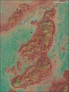 On December 15, 2002, IKONOS captured this image of the remains of Mayan structures in Guatemala. In a natural-color image, the changes caused by the ruins would be hard to distinguish from the natural variation in the green forest canopy. The best way to find them is to look at the visible and near-infrared spectra, shown in this false-color photograph. In this type of image, the forest covering the ruin sites appears yellowish, because the Mayan monuments, built from limestone, affected the chemical make-up of the soil as they deteriorated. 