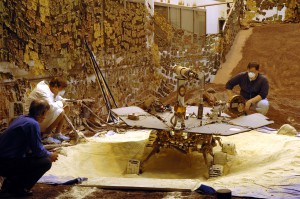 Rover engineers check how a test rover moves in material chosen to simulate some difficult Mars driving conditions. Photo Credit: NASA/JPL