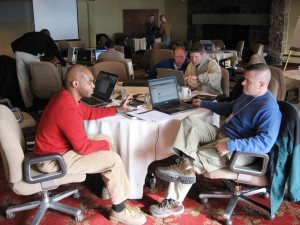 CompanyCommand team members (left to right) Chanda Mofu, Dan Dwyer, Nate Self, and Jay Miseli share ideas during the CC team's annual “OnFire! Rendezvous,” which brings together the team for a face-to-face weekend of camaraderie, training, and planning. All four have led soldiers in combat. Self was awarded the Silver Star for his valor in Afghanistan. Photo Credit: Mark Derber