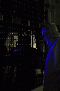 In a clean room at Astrotech, workers begin black light testing on the solar panels of the Dawn spacecraft  