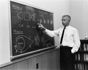 John C. Houbolt at a blackboard, showing his space rendezvous concept for lunar landings. Lunar Orbital Rendezvous was used in the Apollo program.  