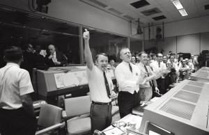 Three of the four Apollo 13 flight directors applaud the successful splashdown of the command module “Odyssey” while Dr. Robert R. Gilruth, director, Manned Spacecraft Center (MSC), and Dr. Christopher C. Kraft Jr., MSC deputy director, light up cigars (upper left). The flight directors are (from left to right) Gerald D. Griffin, Eugene F. Kranz, and Glynn S. Lunney. 