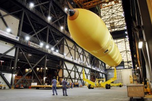 The redesigned external tank for the Return-to-Flight mission is raised above its transporter in the Vehicle Assembly Building at Kennedy Space Center.  Photo Credit: NASA