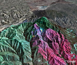 Imagery of the Santiago fire in the mountains of Orange County is draped over a 3–D Google Earth terrain map showing the active fire (yellow), previously burned areas (red), and unburned areas (green).  