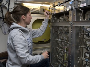 Katrine Gorham of the University of California, Irvine, operates the Whole Air Sampler inside NASA’s DC-8 research aircraft during a flight on April 12, 2008.  