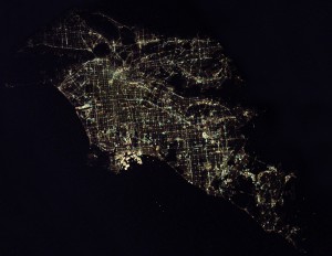 Typical western U.S. cities, Las Vegas (top) and Los Angeles (bottom), are defined by yellow-orange sodium vapor–lit streets in grids. Airport runways stand out as dark lines where, surprisingly, it is better to land an airplane on a dark runway than a well-lit one. At the edge of town, the lights abruptly fade into the surrounding desert. The "Strip" in Las Vegas is probably the brightest spot on Earth.