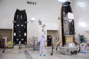 Inside Building 1032 at Vandenberg Air Force Base, technicians install the Orbiting Carbon Observatory spacecraft inside the payload fairing.