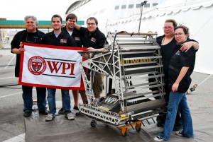 The team from Worcester Polytechnic Institute stands with their excavator Moonraker, which won them $500,000 in the Regolith Excavation Challenge.