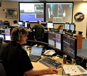 LRO Project Manager Craig Tooley examines data on LRO's orbit insertion around the moon. 
