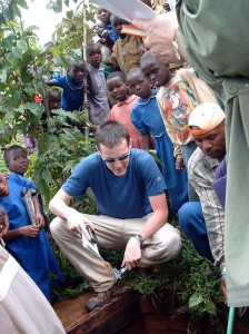 EWB-JSC volunteer Evan Thomas working in Muramba, Rwanda, to assess a surface-water pipeline.