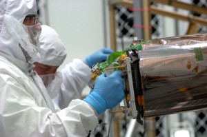 A technician integrates one of the Lunar Reconnaissance Orbiter's narrow-angle camera instruments. 