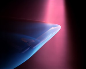 A Space Shuttle model undergoes a wind-tunnel test in 1975. This test simulated the ionized gasses that surround a shuttle as it reenters the atmosphere. (Click image for close-up) 