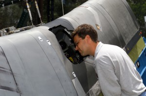 A test engineer inspects the hole created during full-scale testing of the orbiter leading edge.  