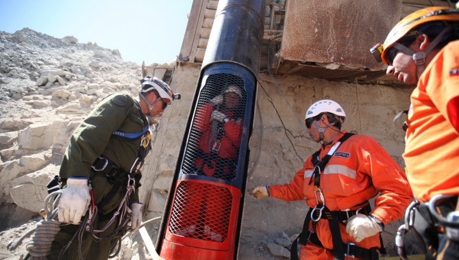 Rescue workers practice a dry run with one of the capsules used to liberate the trapped miners at the San Jose mine near Copiapo, Chile, on October 11, 2010.