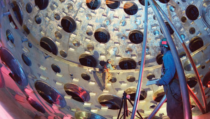 The target chamber under construction. Holes in the target chamber provide access for the laser beams and viewing ports for NIF diagnostic equipment.