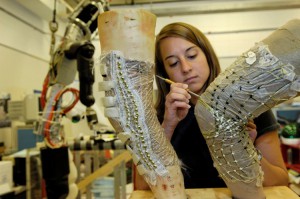 MIT student Kristen Bethke works on the BioSuit knee joint.