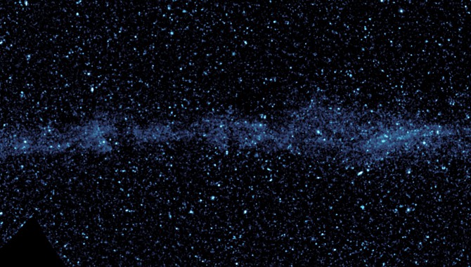 An ultraviolet mosaic from NASA’s Galaxy Evolution Explorer shows a speeding star that is leaving an enormous, 13-light-year-long trail. The star, named Mira (pronounced my-rah), appears as a small white dot in the bulb-shaped structure at right, and is moving from left to right in this view.