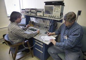 Chuck Antill (NASA, right) and Lewis Horsley (SSAI) perform verification testing on a flight board of the Mars Science Laboratory entry, descent, and landing instrumentation signal-support electronics. 