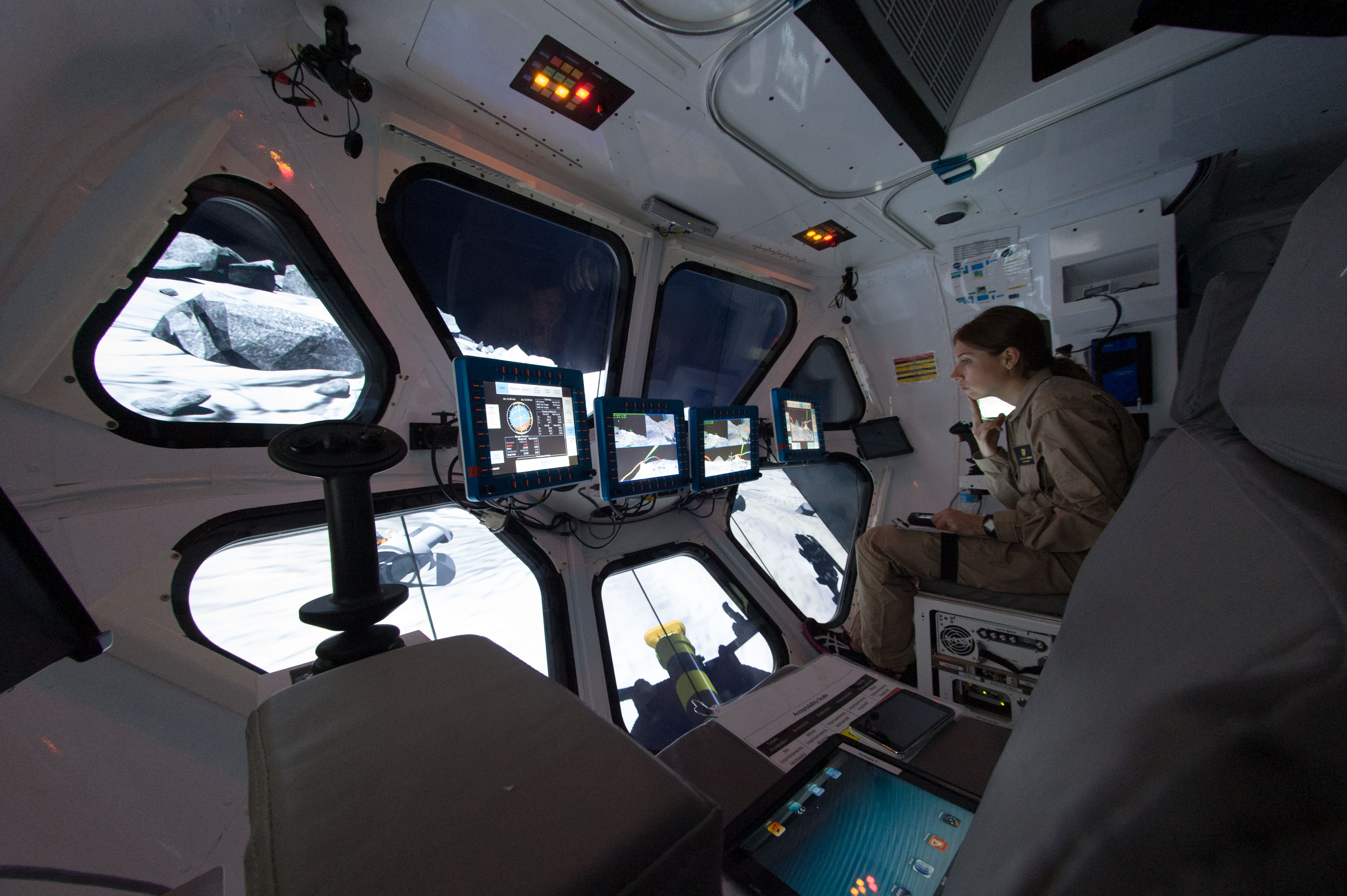 Liz Rampe, a planetary geologist and postdoctoral researcher, pilots the Multi-Mission Space Exploration Vehicle (MMSEV) down to asteroids spinning at different rates as part of the 2012 Research and Technology Studies (RATS) at Johnson Space Center.
