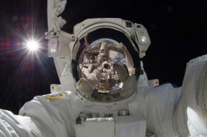 Japan Aerospace Exploration Agency astronaut Aki Hoshide, Expedition 32 flight engineer, uses a digital still camera to expose a photo of his helmet visor during the mission’s third session of extravehicular activity.
