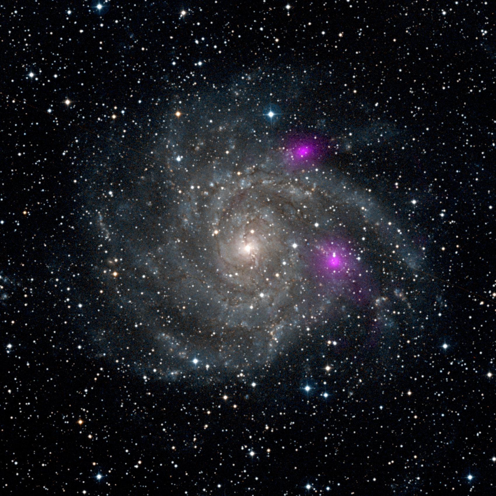 NASA’s Nuclear Spectroscopic Telescope Array, or NuSTAR, caught the glow of two black holes lurking inside spiral galaxy IC342