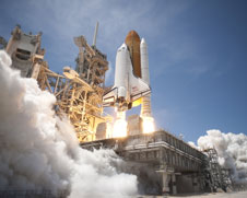 An exhaust plume surrounds the mobile launcher platform on Launch Pad 39A as Space Shuttle Atlantis lifts off on the STS-132 mission