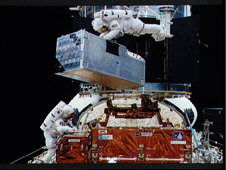 Astronauts Thornton and Akers prepare to install the Corrective Optics Space Telescope Axial Replacement (COSTAR) on the Hubble Space Telescope