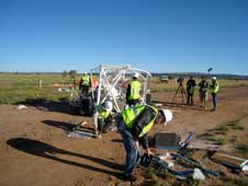 Project personnel inspect damage following a NASA scientific balloon launch mishap