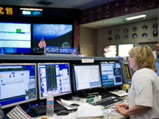 Heather Rarick monitors data in Johnson Space Center's Mission Control Center