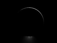 Below a darkened Enceladus, a plume of water ice is backlit in this view of one of Saturn's most dramatic moons.