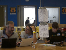 A team in San Francisco puzzles over The Pineapple Project, a software challenge to apply climate data to agricultural planning, during the 2012 International Space Apps Challenge.