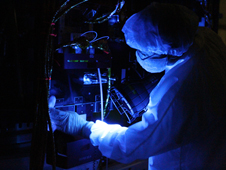 Using a black light, a technician closely inspects one of NASAs Van Allen Probes. Black-light inspection uses UVA fluorescence to detect possible microcontamination, small cracks, or fluid leaks.