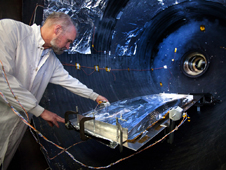 Dan McGregor, lead venting analyst at Northrop Grumman, places a sunshield test article in the vacuum chamber at Aerospace Systems test facility in Redondo Beach, Calif.