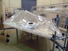 A one-third-scale model of the sunshield was built for testing and refining the teams understanding of thermal issues. Here, one layer of the model undergoes tension testing at the Nexolve facility.