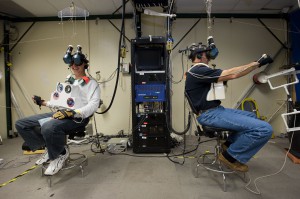 NASA astronauts Clayton Anderson (left) and Rick Mastracchio, both STS-131 mission specialists, use virtual-reality hardware in the Space Vehicle Mock-Up Facility at Johnson Space Center to rehearse some of their duties on an upcoming mission to the International Space Station.