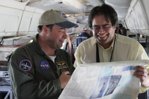 Operation IceBridge Project Scientist Michael Studinger looks over an Antarctic map with Mario Esquivel, a teacher from Punta Arenas, Chile, while returning from a science mission over the Ronne Ice Shelf on November, 1, 2012.