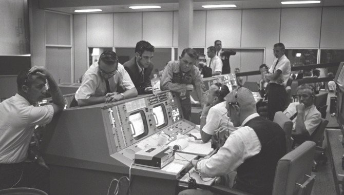 Flight Director Gene Kranz (foreground) and Dr. Christopher Kraft (background) in the Mission Control Center in Houston, Texas, during the Gemini 5 flight.
