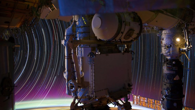 This is a composite of a series of images photographed from a mounted camera on the Earth-orbiting International Space Station, from approximately 240 miles above Earth. Space station hardware in the foreground includes the Mini-Research Module (MRM1, center) and a Russian Progress vehicle docked to the Pirs Docking Compartment (right).