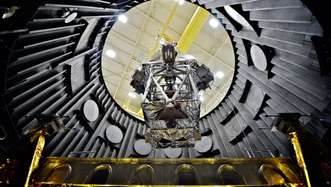 Several critical items related to NASA's next-generation James Webb Space Telescope currently are being tested in the thermal vacuum test chamber at NASA's Goddard Space Flight Center, Greenbelt, Md. This image shows the Optical Telescope Element Simulator, or OSIM, wrapped in a silver blanket on a platform, being lowered into the Space Environment Simulator vacuum chamber via crane to be tested to withstand the cold temperatures of space.