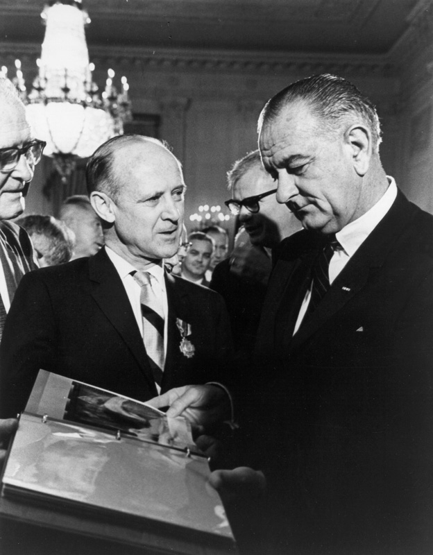 Dr. William H. Pickering (left), Director of the Jet Propulsion Laboratory, presents Mariner spacecraft photos to President Lyndon Baines Johnson in 1964.