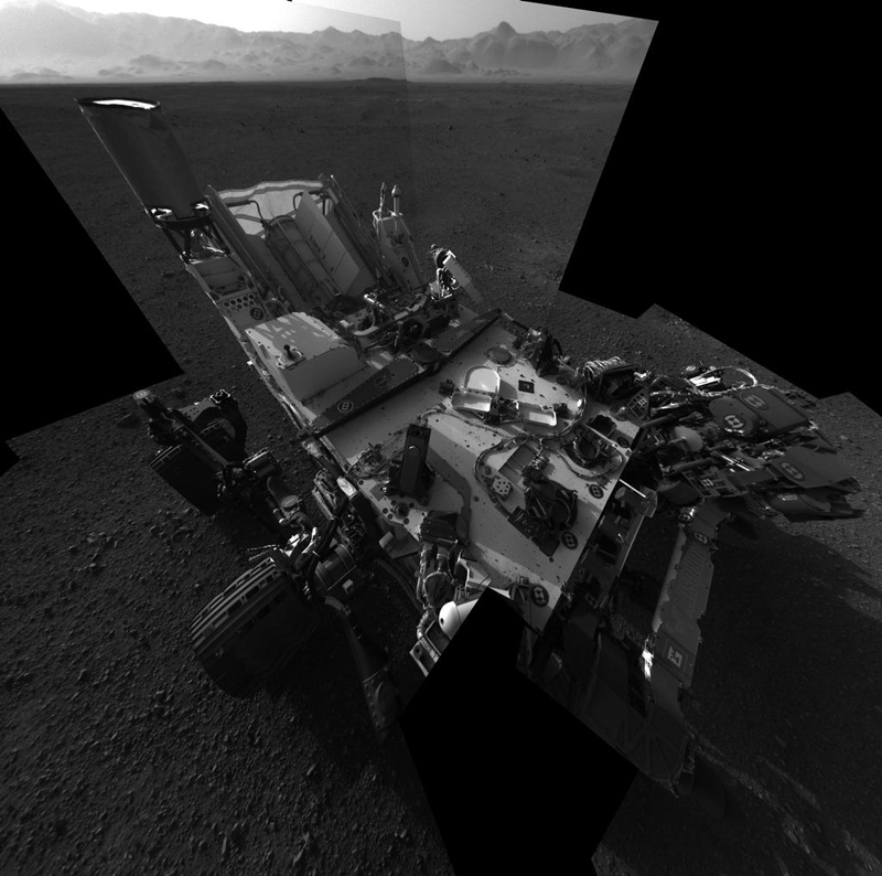 This full-resolution self-portrait shows the deck of NASA's Curiosity rover from the rover's Navigation camera. The back of the rover can be seen at the top left of the image, and two of the rover's right side wheels can be seen on the left. The undulating rim of Gale Crater forms the lighter color strip in the background. Bits of gravel, about 0.4 inches (1 centimeter) in size, are visible on the deck of the rover.