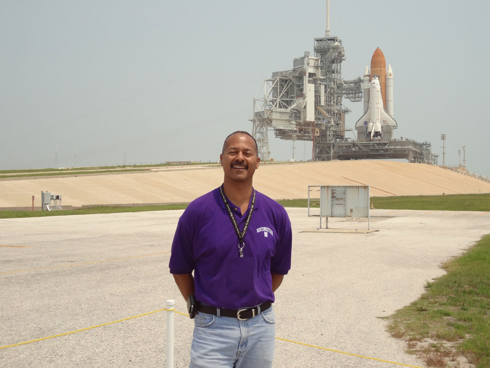 Michael Bell, KSC Chief Knowledge Officer, standing in front of Atlantis before her last launch, STS-135, and the last mission of the Space Shuttle Program.