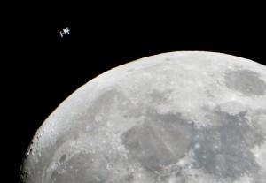 The International Space Station can be seen as a small object in upper left of this image of the moon in the early evening Jan. 4 in the skies over the Houston area flying at an altitude of 390.8 kilometers (242.8 miles).