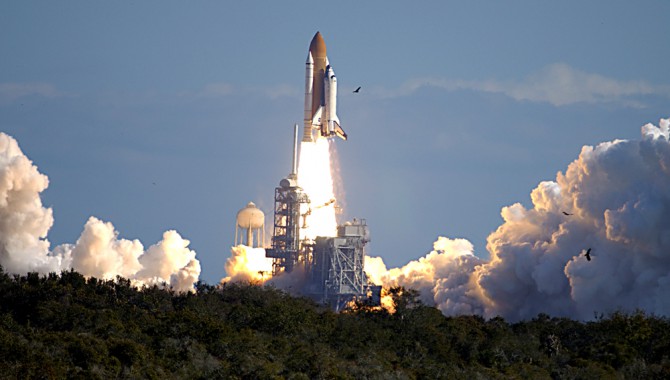 Through a cloud-washed blue sky above Launch Pad 39A, Space Shuttle Columbia hurtles toward space on mission STS-107. Following the countdown, liftoff occurred on-time at 10:39 EST. Experiments in the SPACEHAB module ranged from material sciences to life sciences.