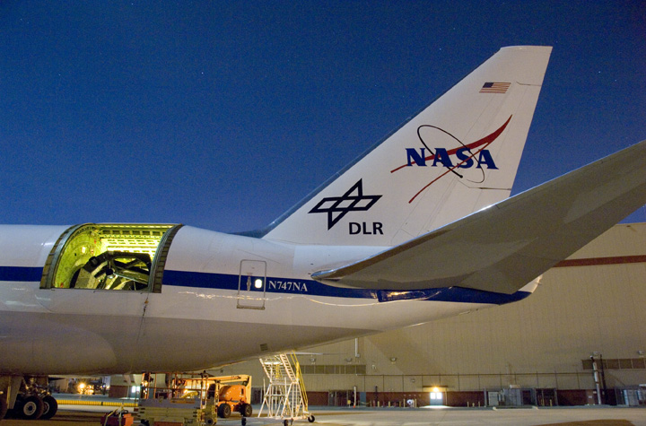 The SOFIA airborne observatory's 2.5-meter infrared telescope peers out from its cavity in the SOFIA rear fuselage during nighttime line operations testing. Photo Credit: NASA
