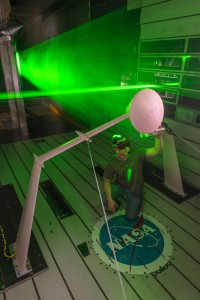 The NESC sponsored this measurement of the wake deficit behind an 8%-scale model of an Orion crew module in the 11-Foot Transonic Wind Tunnel at Ames Research Center using laser-based particle image velocimetry. T.J Heineck is shown checking alignment of the laser used to measure particle flow in the tunnel. Photo Credit: NASA