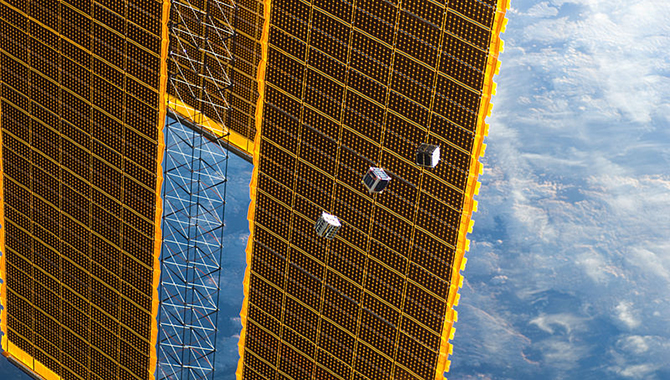 Several tiny CubeSat satellites are shown in this image photographed by an Expedition 33 crew member on the International Space Station on 4 October 2012. The satellites were released outside the Kibo laboratory using a Small Satellite Orbital Deployer attached to the Japanese module's robotic arm. Japan Aerospace Exploration Agency astronaut Aki Hoshide, flight engineer, set up the satellite deployment gear inside the laboratory and placed it in the Kibo airlock. The Japanese robotic arm then grappled the deployment system and its satellites from the airlock for deployment. A portion of the station's solar array panels and a blue and white part of the earth provide the backdrop for the scene.