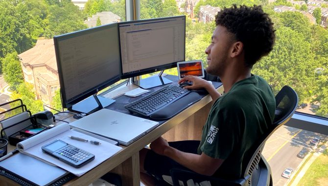 A Glenn Research Center intern is working on the computer. Credit: NASA