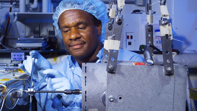 Man inside the Fluids and Combustion Facility (FCF). Credit: NASA