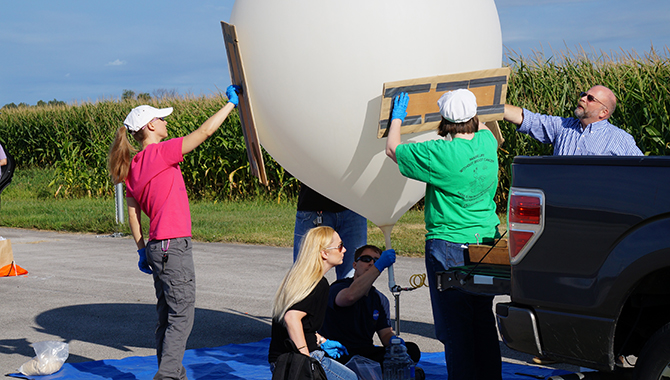 Members of Glenn Research Center’s pilot Rocket U program prepare the balloon for their flight project. From left to right: Kristen Bury, Amanda Stevenson, Justin Niehaus, Deb Goodenow, and Dave Wolford. Behind the balloon: Fransua Thomas. Photo credit: Anthony Roberts/NASA